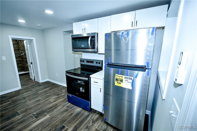 kitchen with dark hardwood / wood-style floors, appliances with stainless steel finishes, and white cabinetry