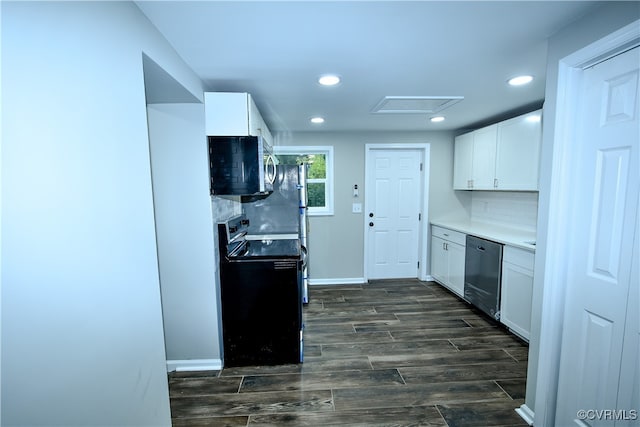 kitchen featuring dark hardwood / wood-style flooring, backsplash, stainless steel appliances, and white cabinets