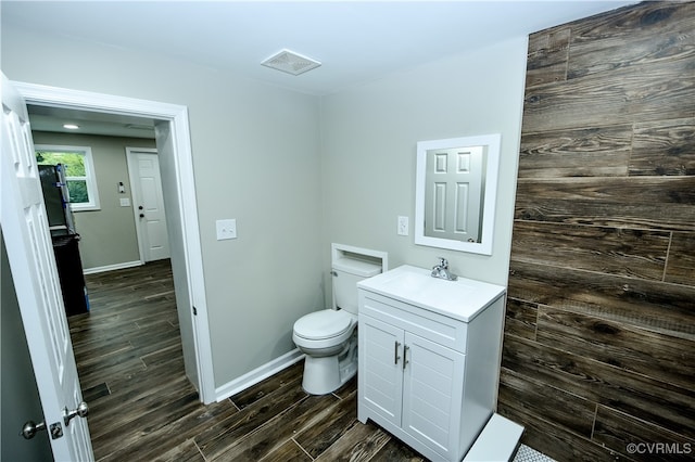 bathroom featuring hardwood / wood-style floors, vanity, and toilet