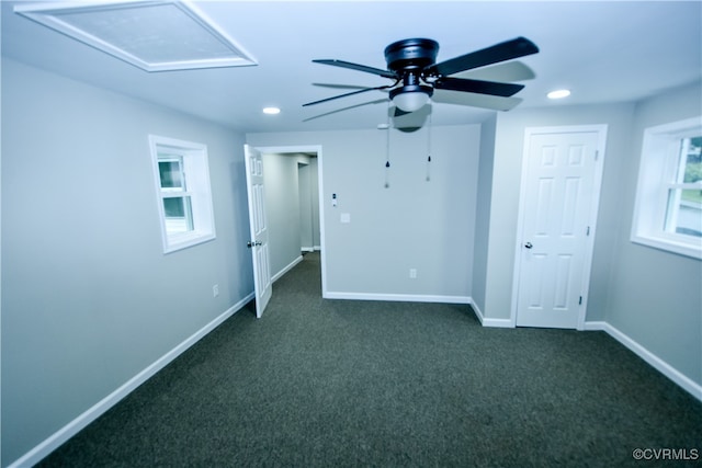 unfurnished bedroom featuring ceiling fan and dark carpet