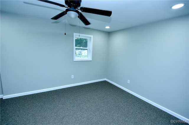 empty room featuring ceiling fan and carpet