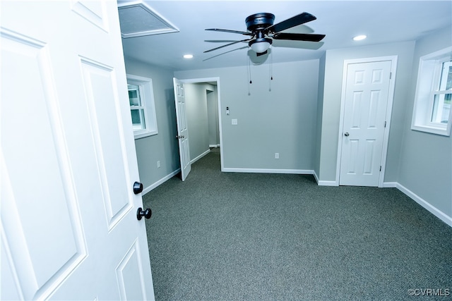 unfurnished bedroom featuring ceiling fan and dark carpet