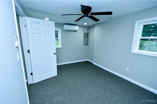 spare room featuring dark colored carpet, ceiling fan, a wall mounted air conditioner, and electric panel