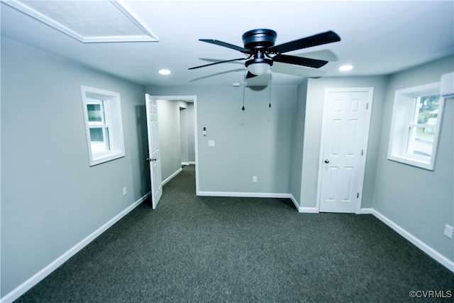 unfurnished bedroom featuring dark colored carpet and ceiling fan