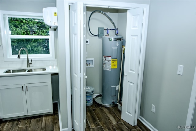 utility room with water heater and sink