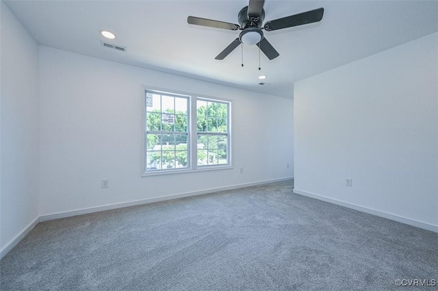 spare room with carpet and ceiling fan