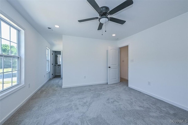 unfurnished bedroom with light carpet and ceiling fan