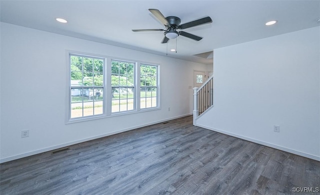 unfurnished room with dark hardwood / wood-style flooring and ceiling fan