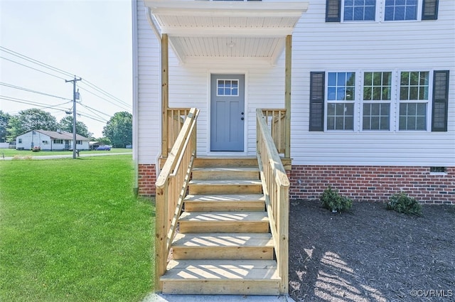 doorway to property with a yard