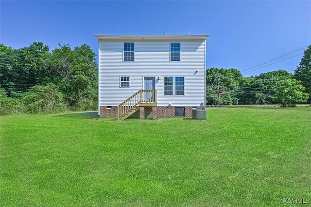 back of property with cooling unit and a yard