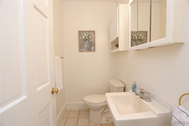 bathroom featuring tile patterned floors, toilet, and sink