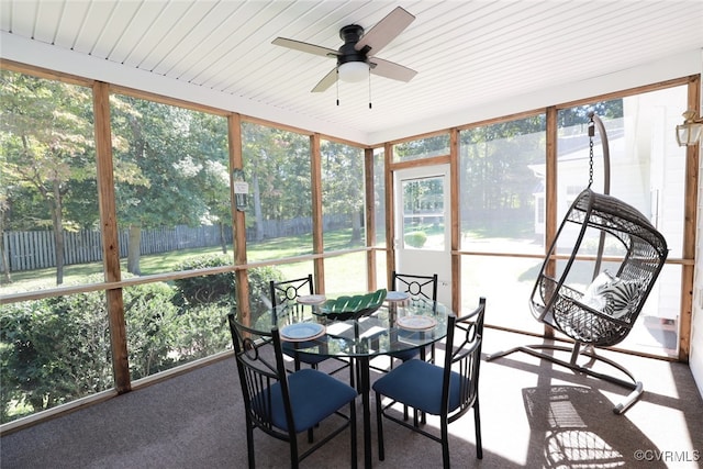 sunroom with ceiling fan and plenty of natural light