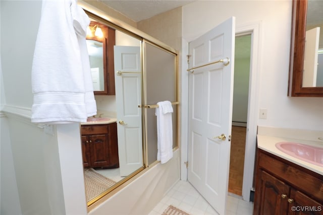 bathroom featuring shower / bath combination with glass door, tile patterned floors, vanity, and a baseboard heating unit