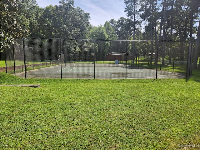 view of sport court with a yard