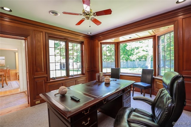 home office with ceiling fan, crown molding, and light colored carpet