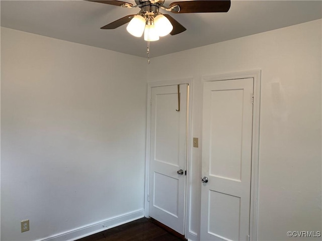 empty room featuring ceiling fan and dark hardwood / wood-style floors