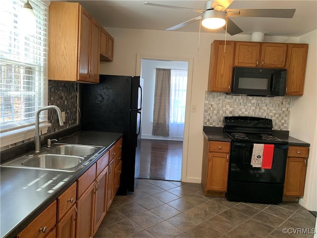 kitchen featuring backsplash, ceiling fan, sink, and black appliances