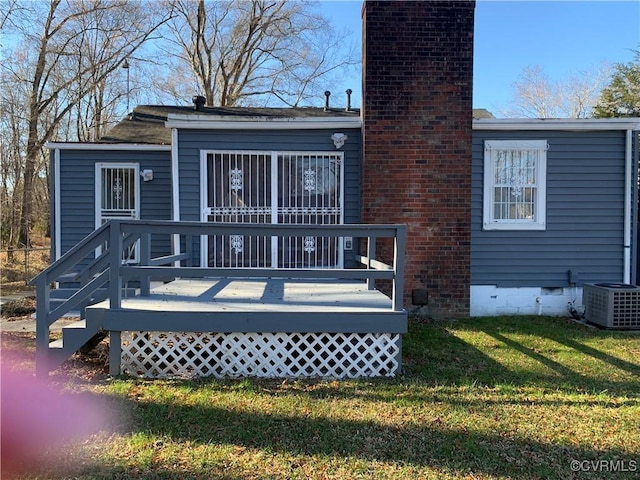 back of house with a lawn, cooling unit, and a wooden deck