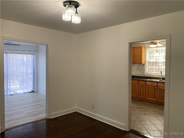 unfurnished dining area with wood-type flooring and sink