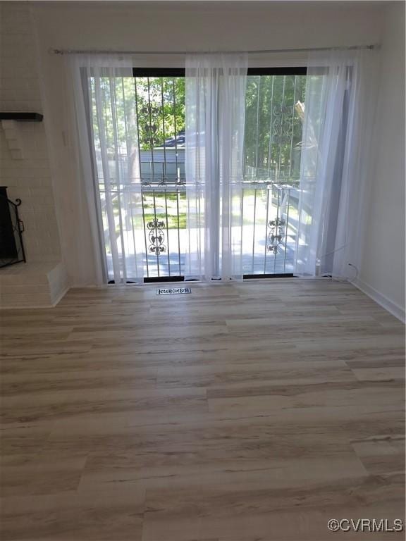 73 Henrico St, Petersburg, VA 23803 - unfurnished living room featuring wood finished floors and baseboards