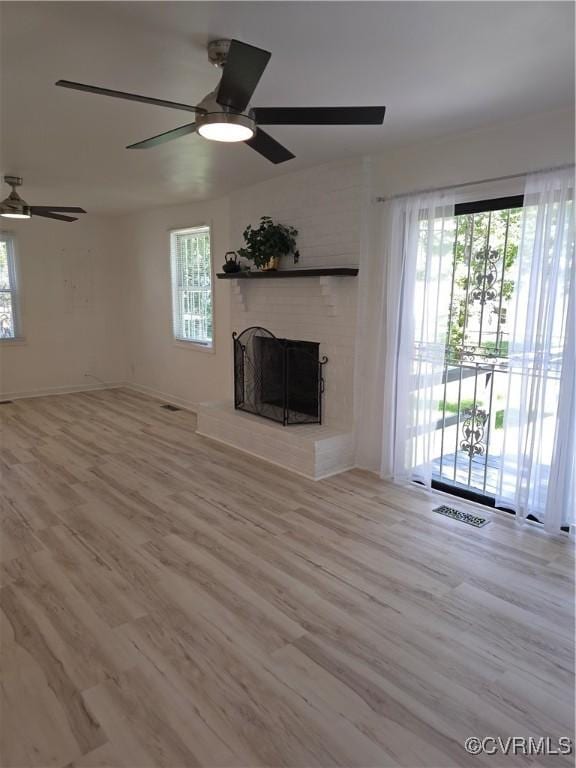 73 Henrico St, Petersburg, VA 23803 - unfurnished living room with ceiling fan, healthy amount of natural light, and wood finished floors