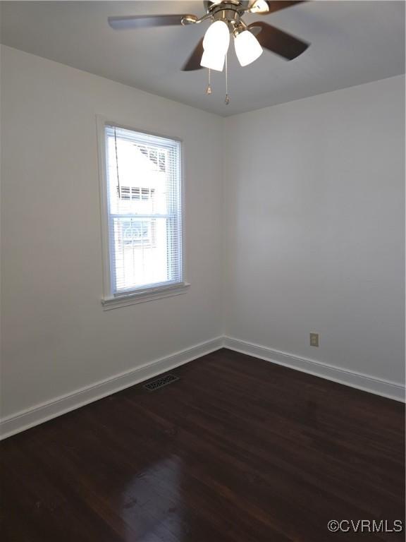 73 Henrico St, Petersburg, VA 23803 - unfurnished room with dark wood-style flooring, baseboards, and a ceiling fan