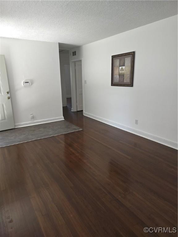 73 Henrico St, Petersburg, VA 23803 - empty room featuring dark wood-style flooring, baseboards, and a textured ceiling