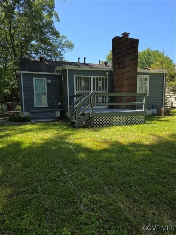 73 Henrico St, Petersburg, VA 23803 - back of property featuring a yard, a deck, and central air condition unit