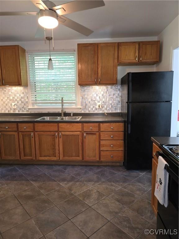 73 Henrico St, Petersburg, VA 23803 - kitchen featuring a sink, brown cabinets, dark countertops, and black appliances