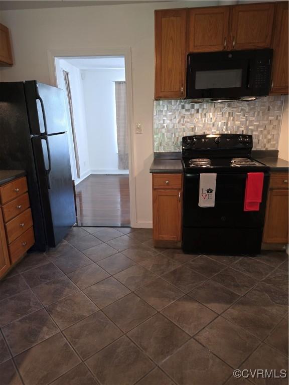 73 Henrico St, Petersburg, VA 23803 - kitchen featuring black appliances, dark countertops, decorative backsplash, and dark tile patterned floors