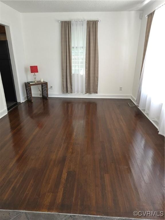 73 Henrico St, Petersburg, VA 23803 - empty room with wood finished floors and baseboards
