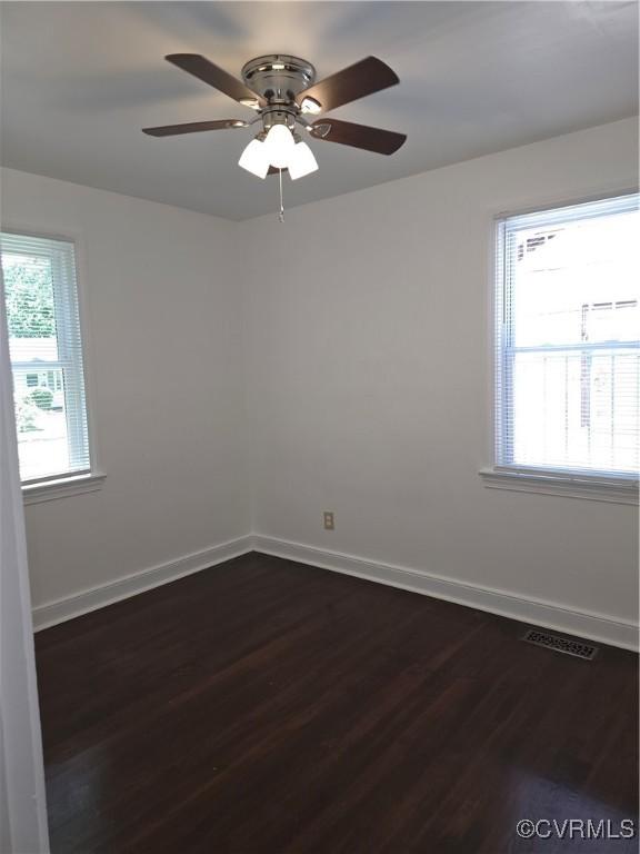73 Henrico St, Petersburg, VA 23803 - empty room featuring dark wood finished floors, baseboards, and healthy amount of natural light