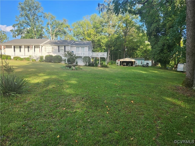 view of yard featuring a carport and a deck