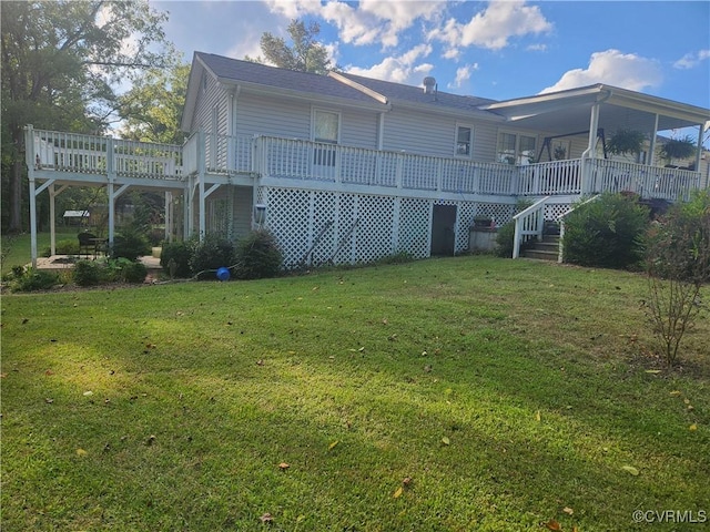 rear view of house featuring stairway and a yard