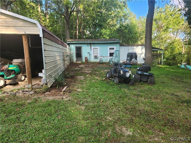 back of house featuring a lawn and an outdoor structure