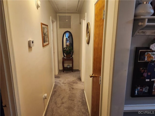 corridor with visible vents, carpet floors, attic access, and baseboards