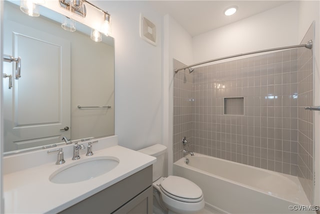 full bathroom with toilet, vanity, and tiled shower / bath