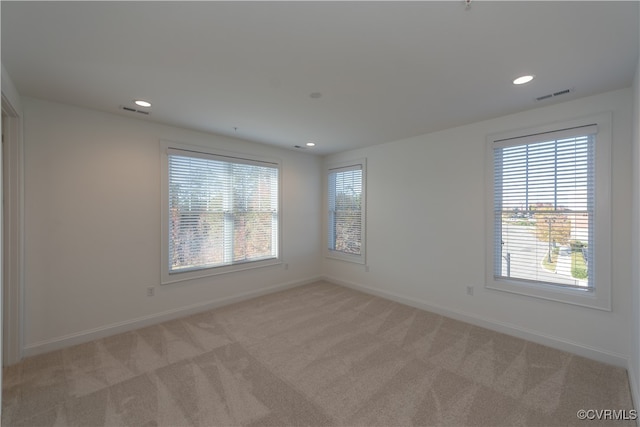 empty room featuring light carpet