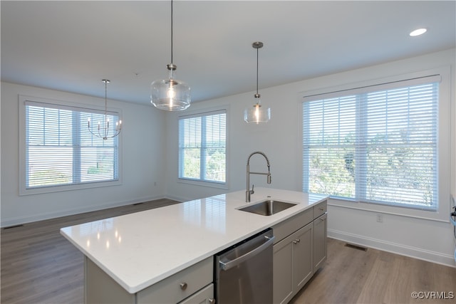 kitchen with a center island with sink, dishwasher, sink, and a wealth of natural light