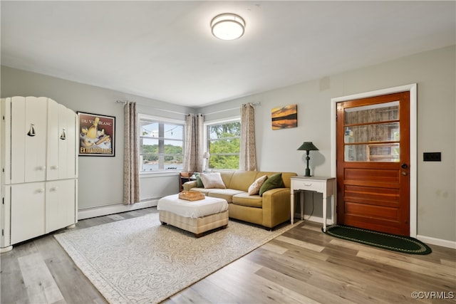 living room with a baseboard radiator and light hardwood / wood-style floors