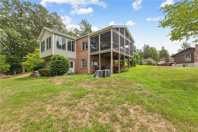 back of house with a lawn and a sunroom