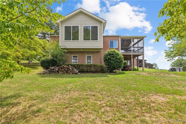 view of front of house with a front yard and a sunroom