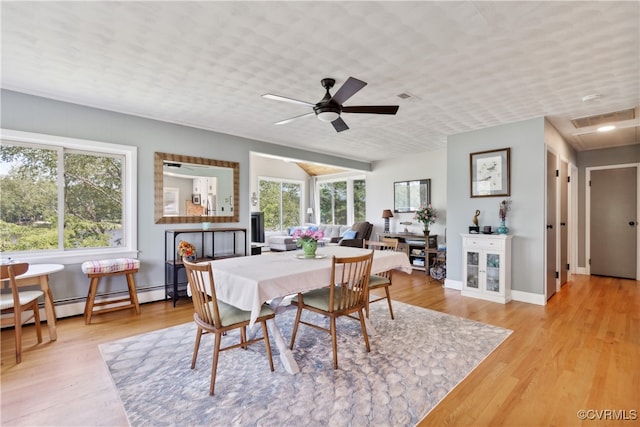 dining room featuring light wood-type flooring, ceiling fan, and plenty of natural light