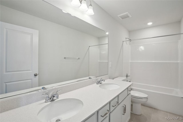 bathroom with tile patterned flooring, a sink, double vanity, and toilet