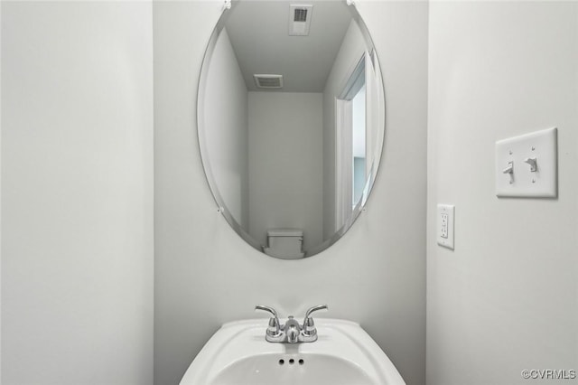 bathroom featuring visible vents and a sink