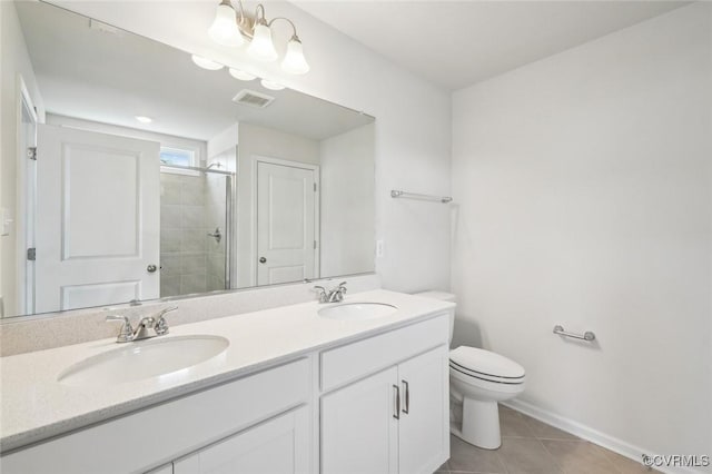 bathroom with a tile shower, tile patterned flooring, toilet, and a sink