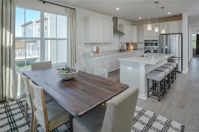 15436 Greenhart Dr, Chesterfield, VA 23832 - kitchen with stainless steel appliances, wall chimney range hood, healthy amount of natural light, white cabinetry, and recessed lighting