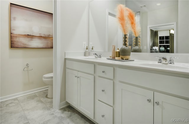 bathroom featuring vanity and toilet