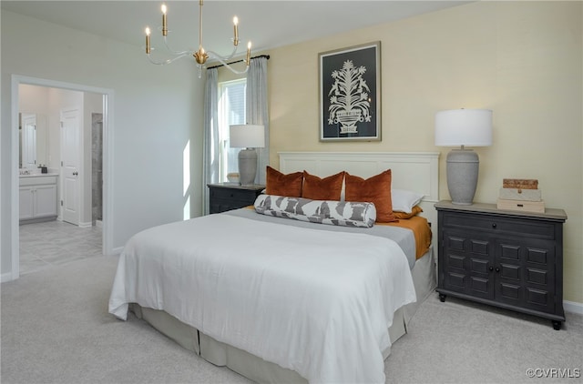 bedroom with light colored carpet, an inviting chandelier, and ensuite bath