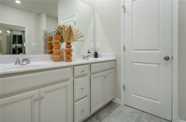 bathroom featuring tile patterned flooring, vanity, and an inviting chandelier